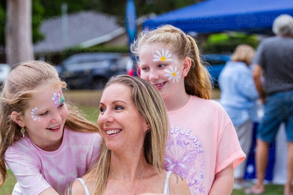 Portrait of Aussie mum and two daughters together at summer time event - Australian Stock Image