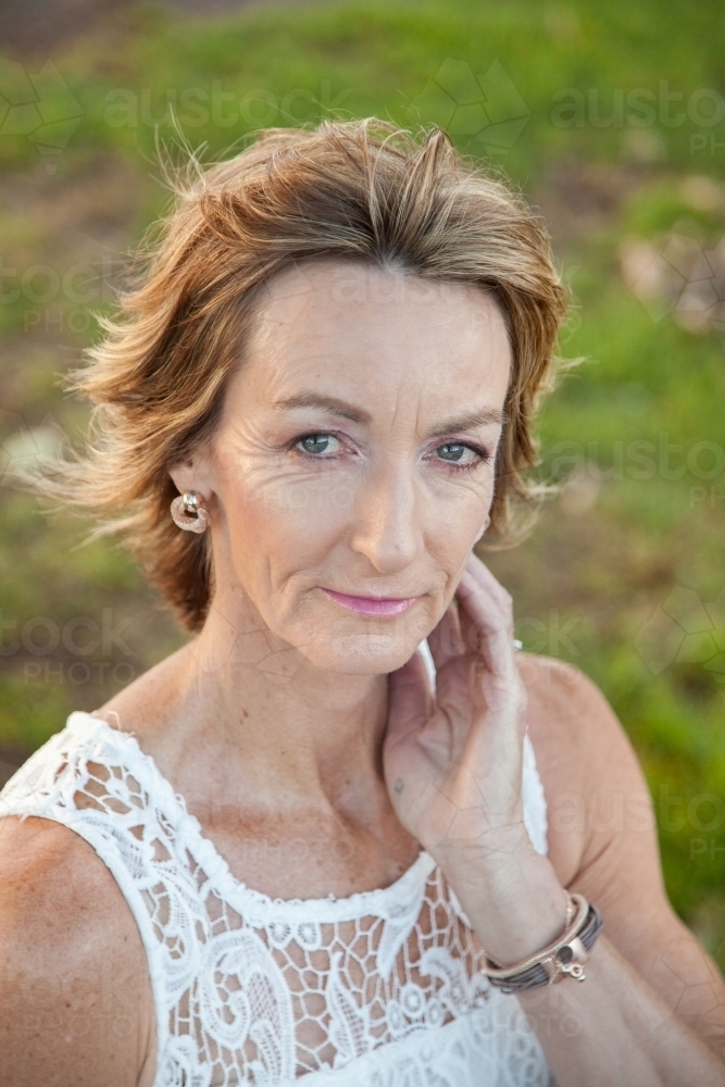 Portrait of beautiful middle aged lady looking at camera - Australian Stock Image