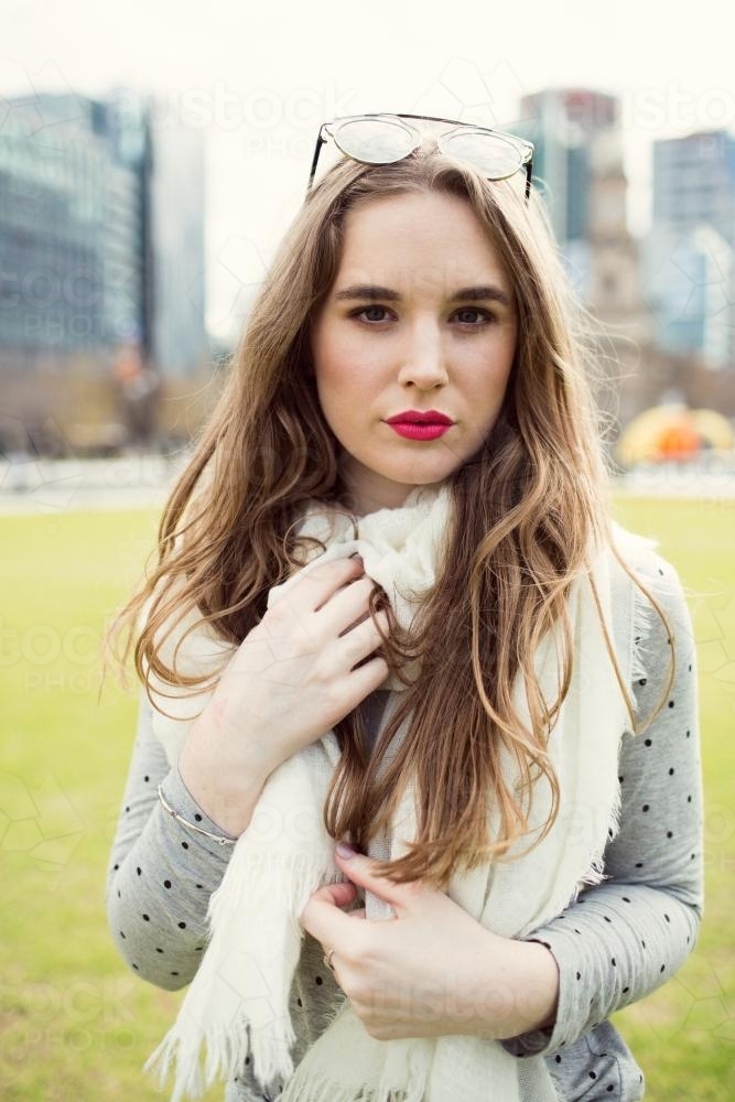 Portrait of fashionable young woman posing in a city park - Australian Stock Image