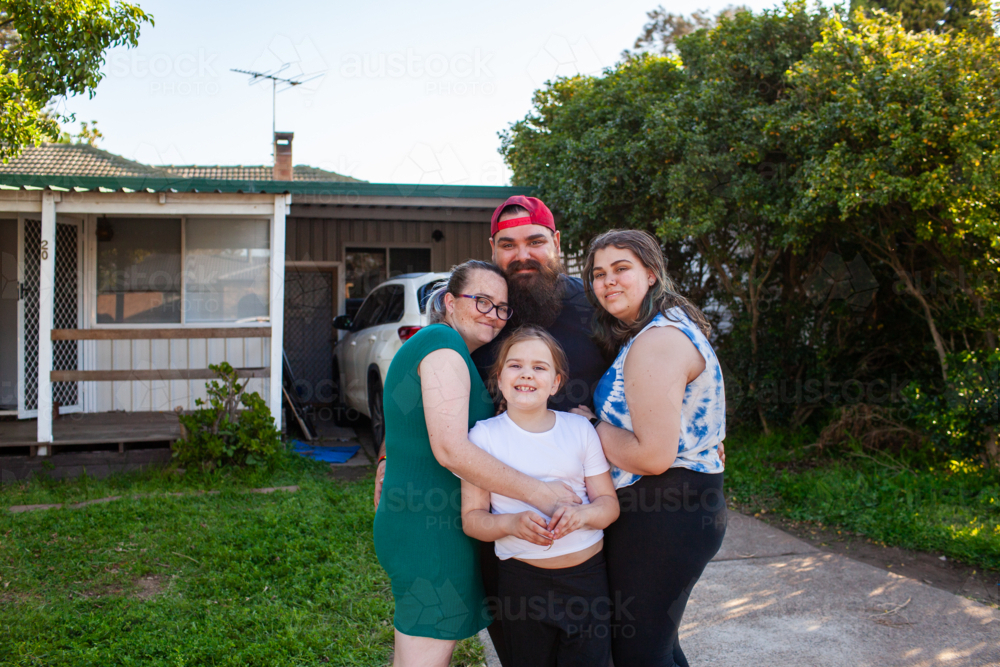 Portrait of First Nations Australian family outside suburban home - Australian Stock Image