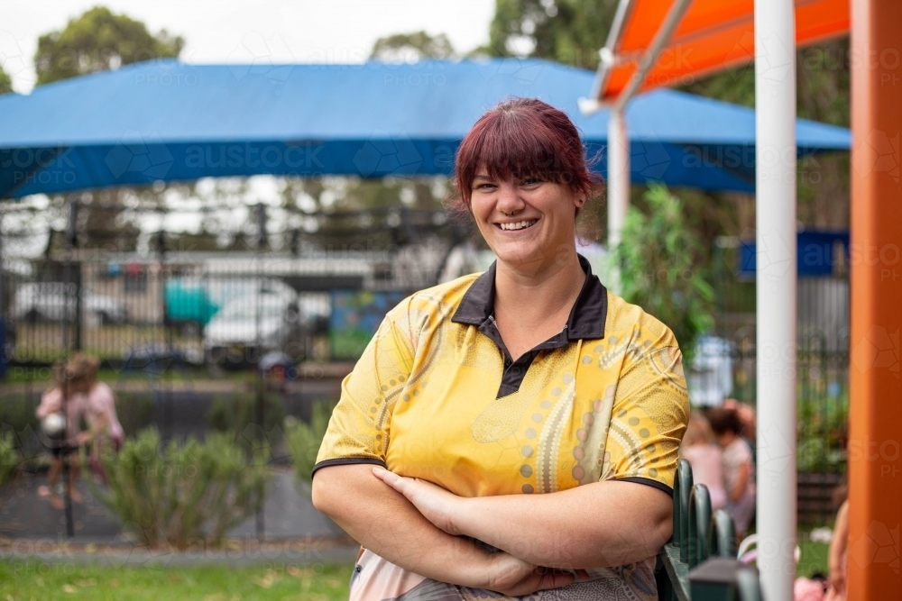 Portrait of happy confident female preschool teacher - Australian Stock Image