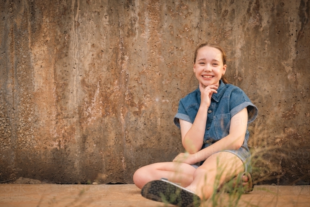 Portrait of happy pre-teen girl in rustic country setting - Australian Stock Image