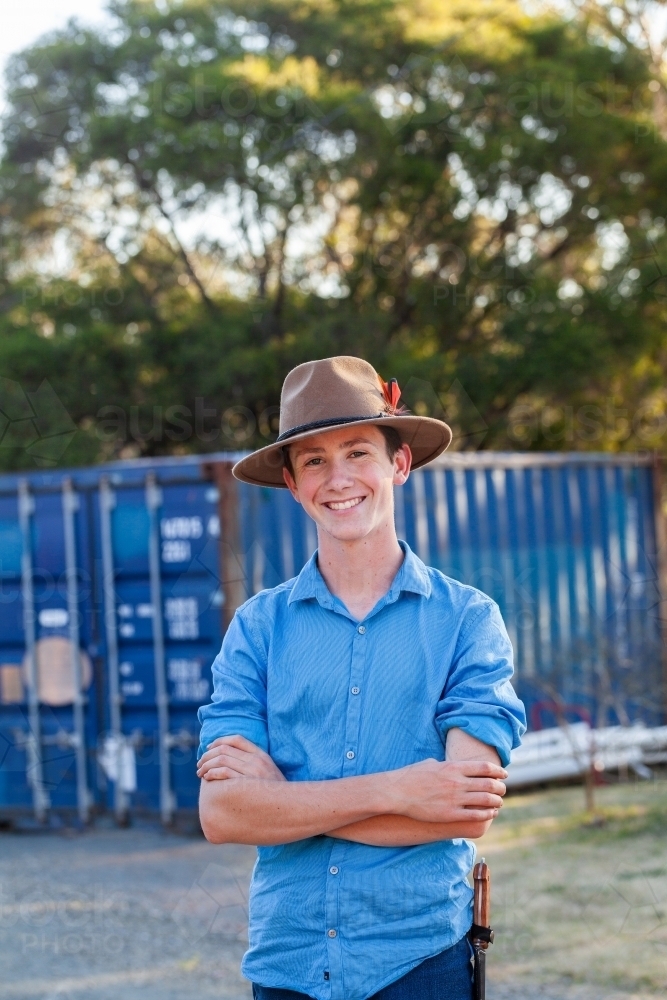 Portrait of happy teen boy with aussie hat in blue shirt - Australian Stock Image