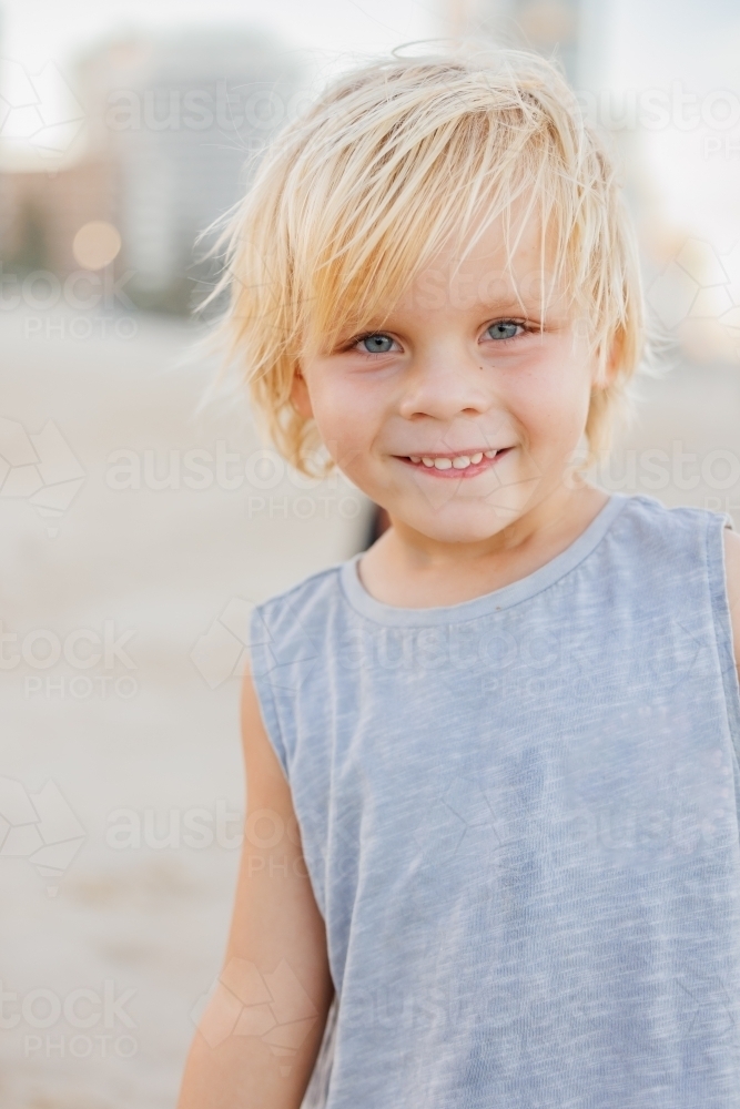 Portrait of little boy smiling on the beach - Australian Stock Image