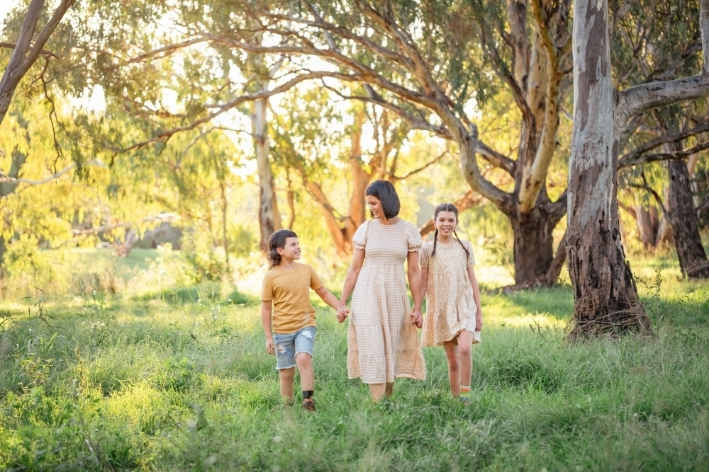 Portrait of mother and children walking together in Australian bush setting - Australian Stock Image