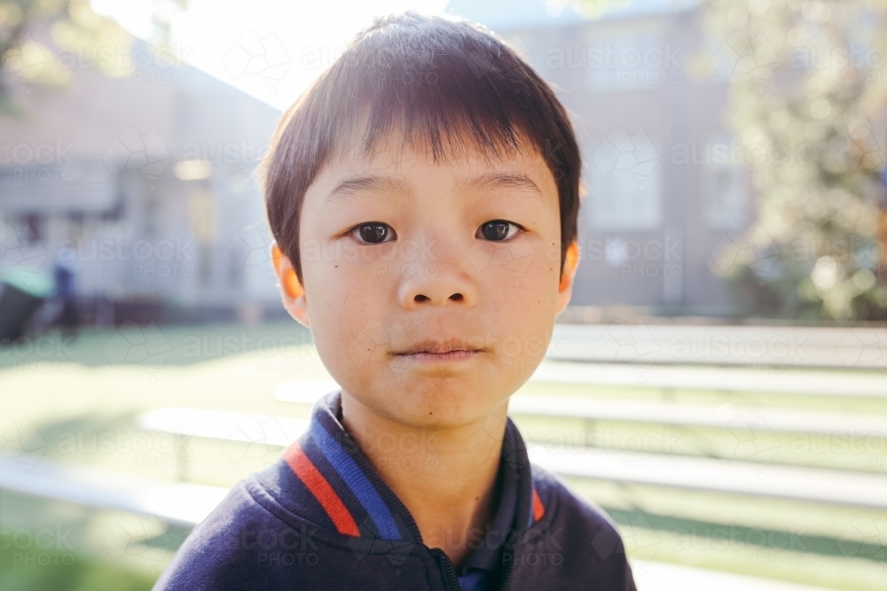 Portrait of primary school boy in the playground at school - Australian Stock Image