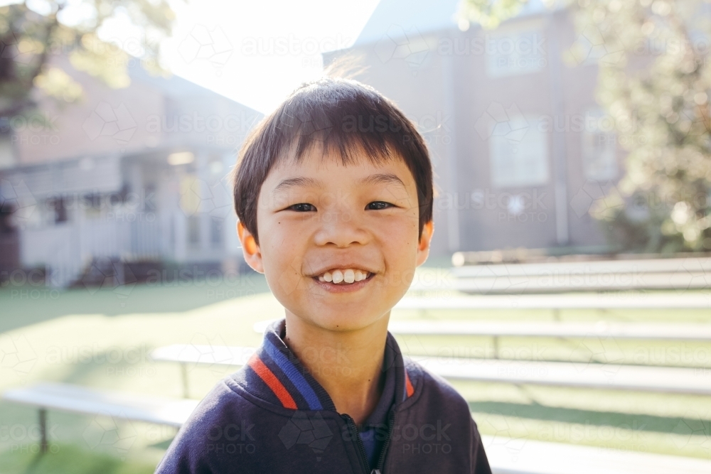 Portrait of primary school boy in the playground at school - Australian Stock Image