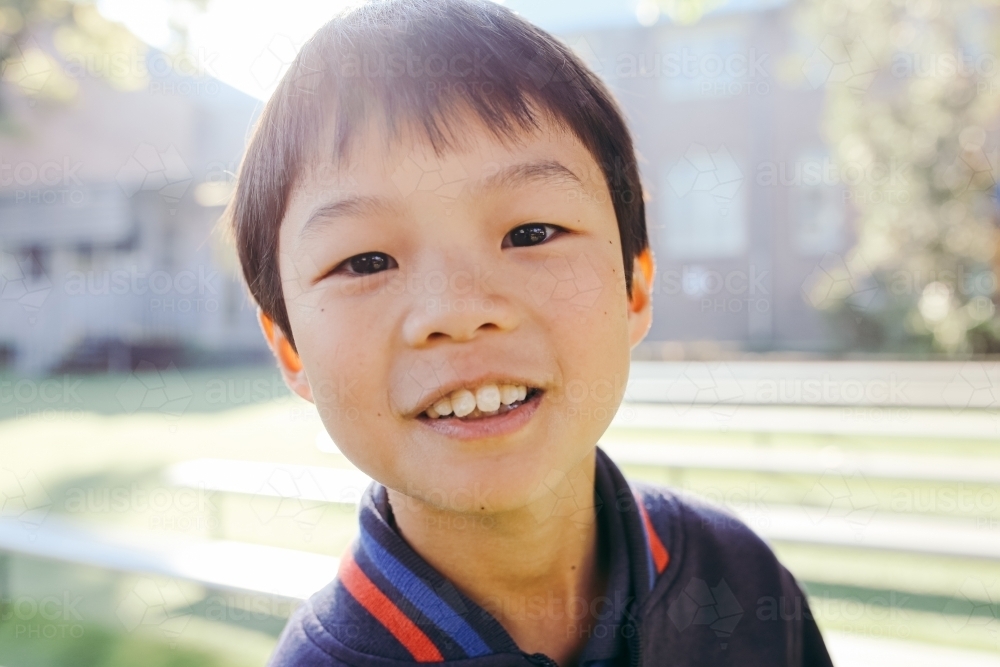 Portrait of primary school boy in the playground at school - Australian Stock Image