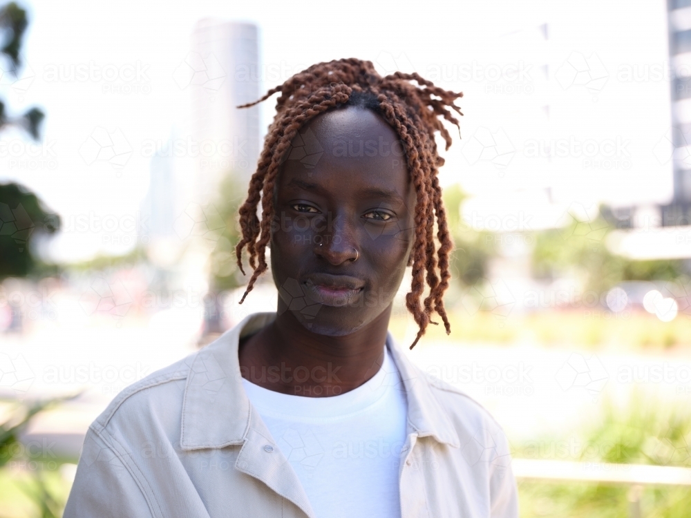 Portrait of Sudanese man wearing a jacket outside - Australian Stock Image