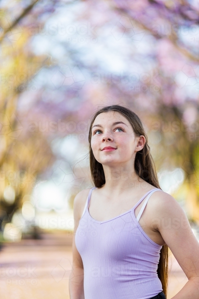 Portrait of teen girl looking up dreamily - Australian Stock Image