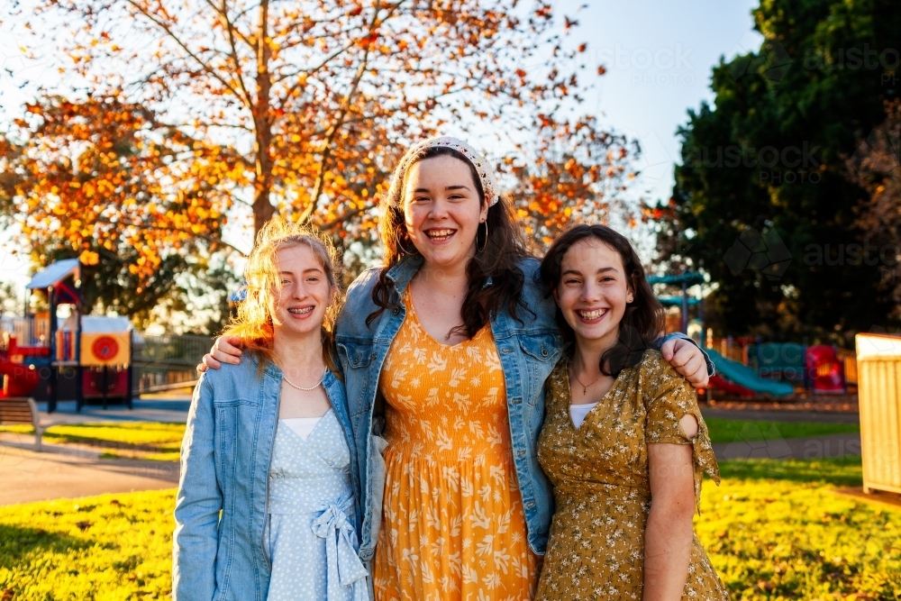 Image of Portrait of three smiling Aussie teenagers standing in group ...
