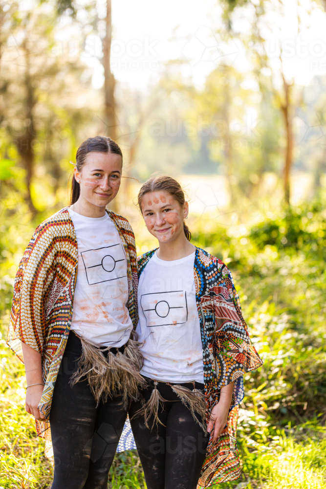 Portrait of two happy aboriginal sisters together outside - Australian Stock Image