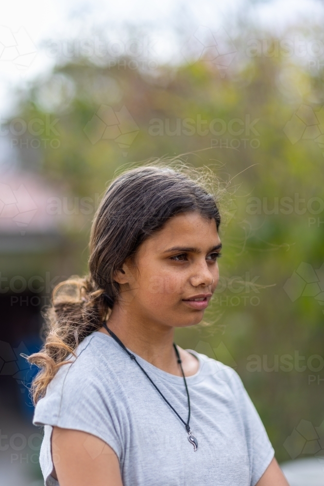 portrait of young aboriginal girl in vertical format with copy space - Australian Stock Image