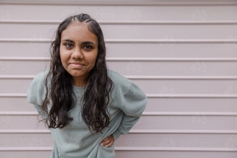 Portrait of young Aboriginal woman leaning forward - Australian Stock Image