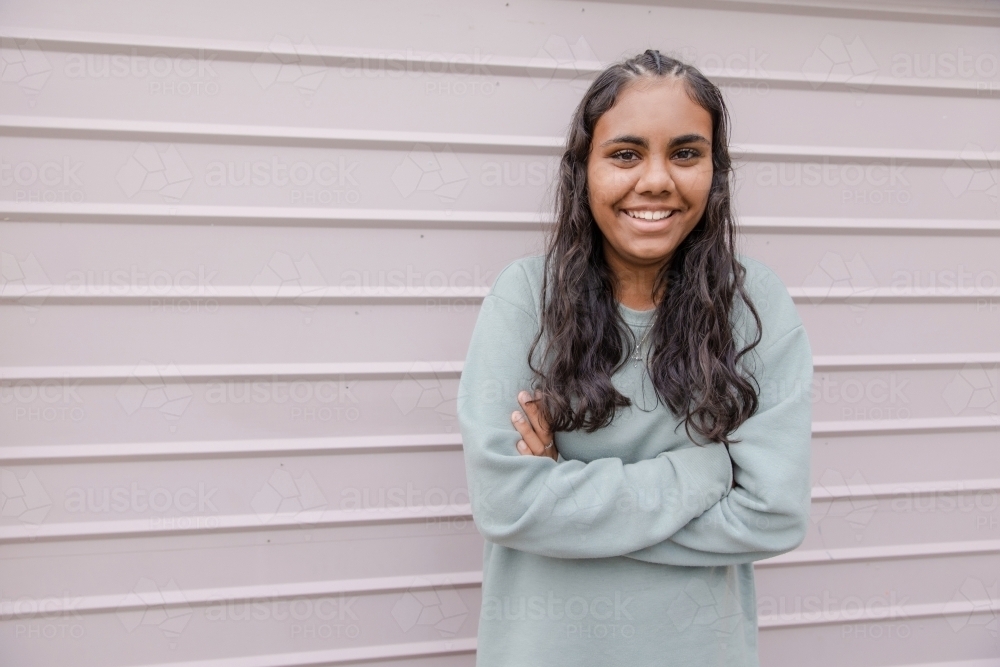 Portrait of young Aboriginal woman with folded arms - Australian Stock Image