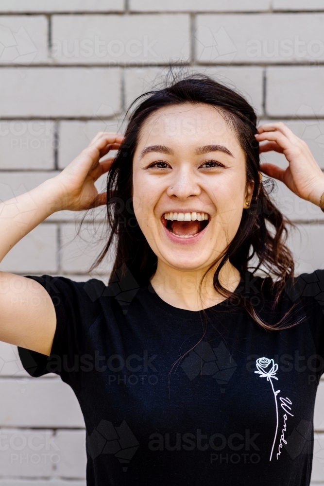 portrait of young, laughing asian woman - Australian Stock Image