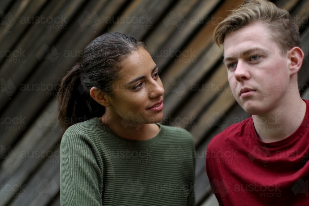 Portrait of young mixed race couple in serious conversation - Australian Stock Image