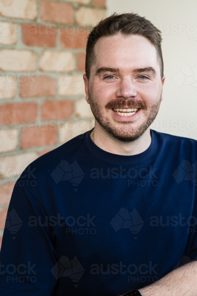 portrait, smiling gay man in his 30s - Australian Stock Image