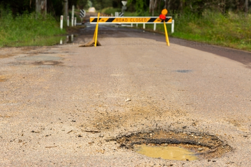 Pothole in road with road closed sign behind - Australian Stock Image