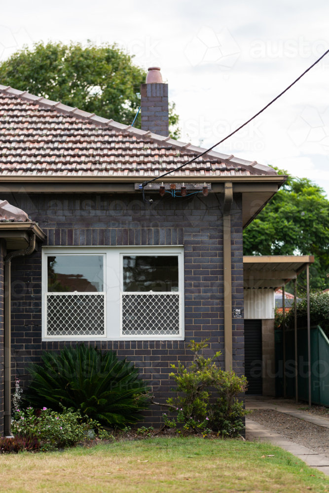 Image of Power connection point to house with tiled roof and driveway ...