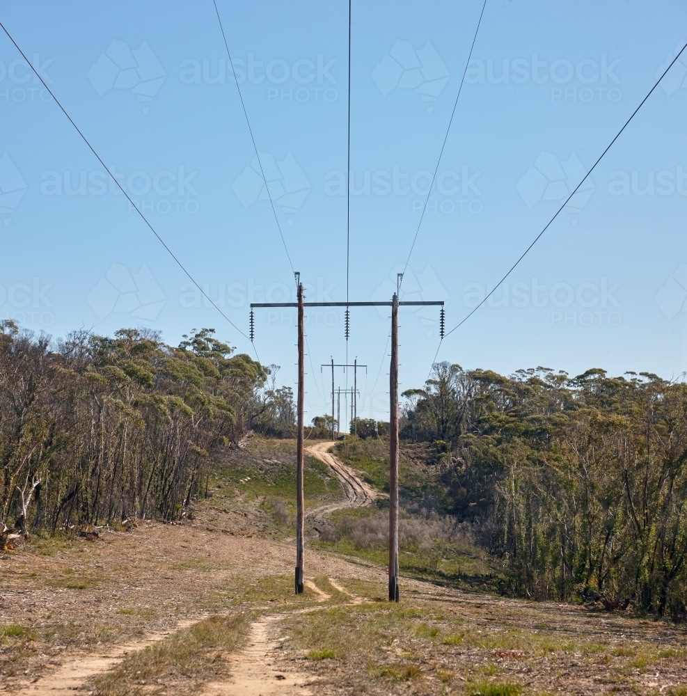 Power lines running through cleared bushland - Australian Stock Image