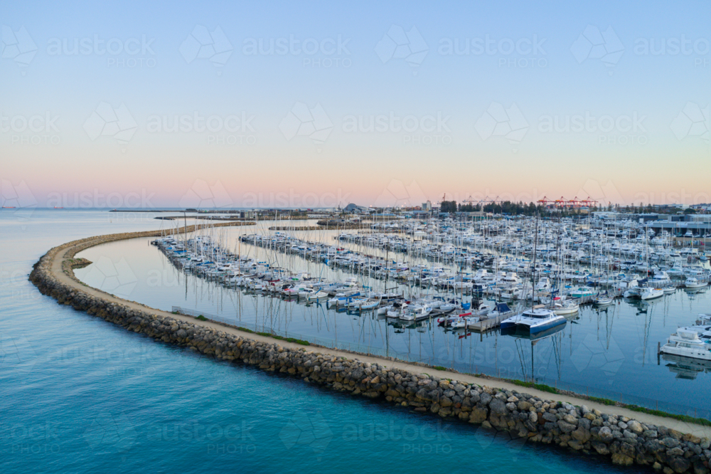 Pre-dawn view across yachts moored in a marina in Fremantle, Western Australia - Australian Stock Image