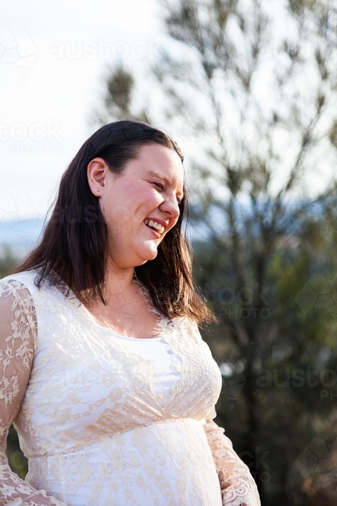 Pregnant woman laughing for joy - Australian Stock Image