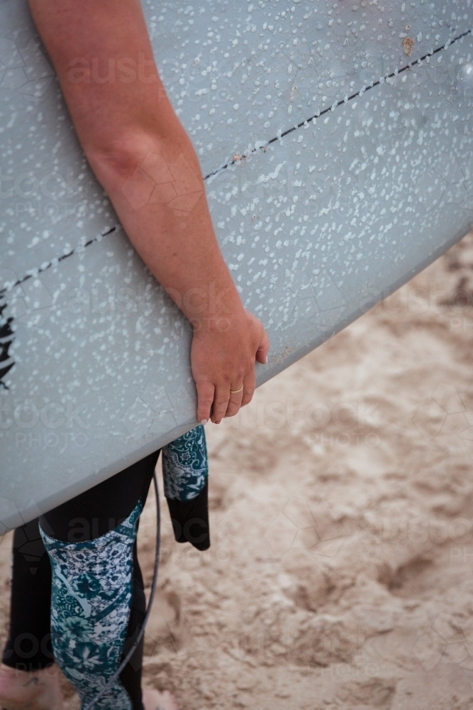 Preparing to Surf with waxed surfboard - Australian Stock Image