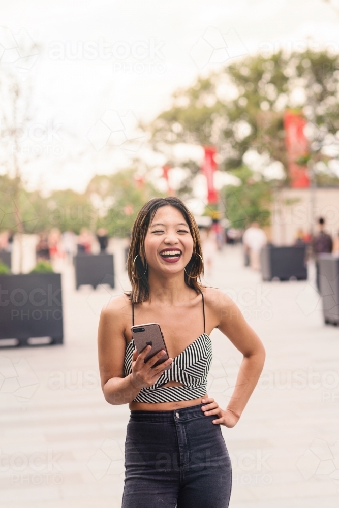 pretty asian woman with phone - Australian Stock Image