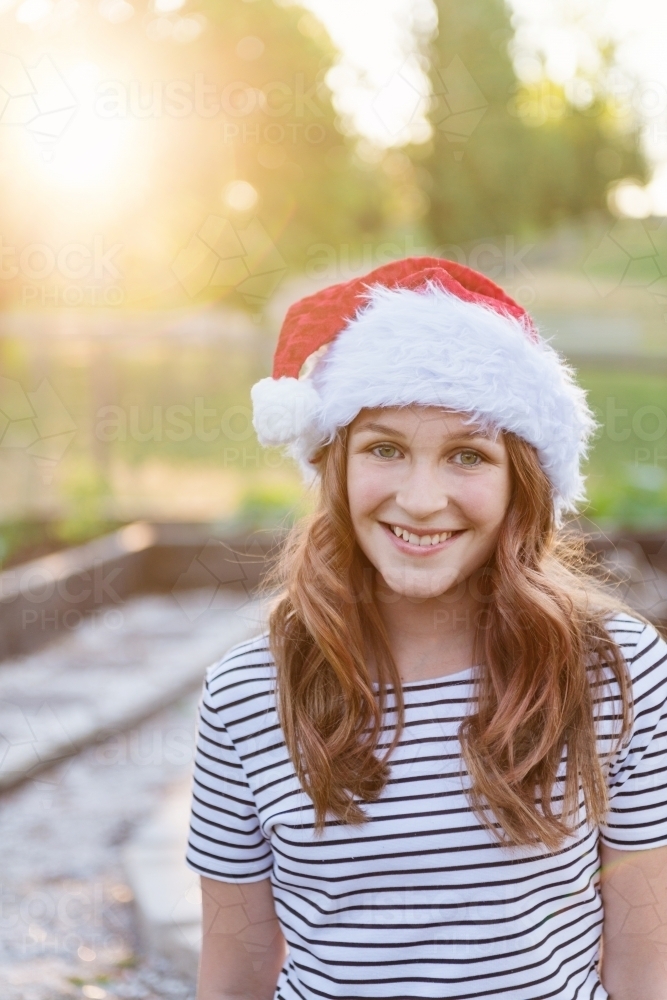 pretty teen girl wearing xmas santa hat - Australian Stock Image