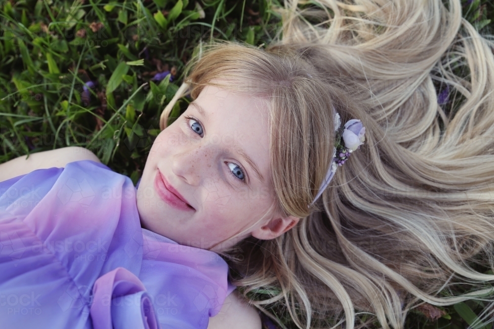 Pretty young girl lying on the grass - Australian Stock Image