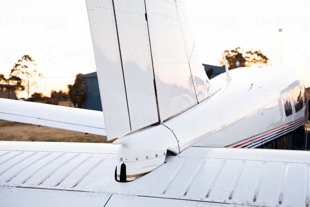 Private twin engine aeroplane on rural landing strip at dusk - Australian Stock Image