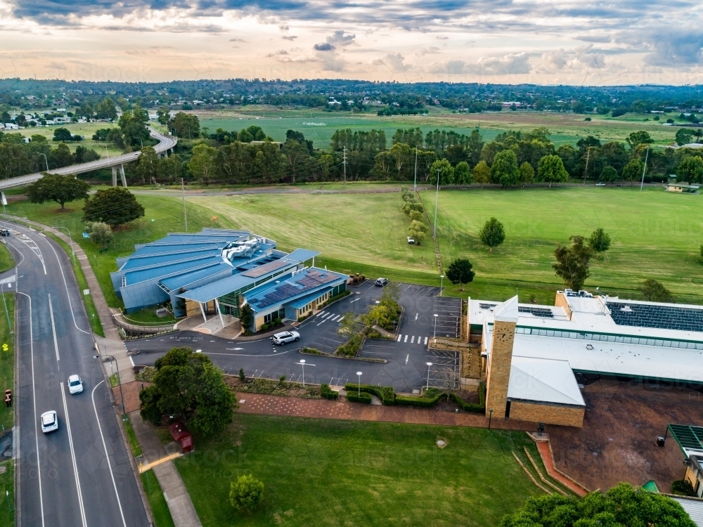 Public library and council building with sports field at dusk - Australian Stock Image