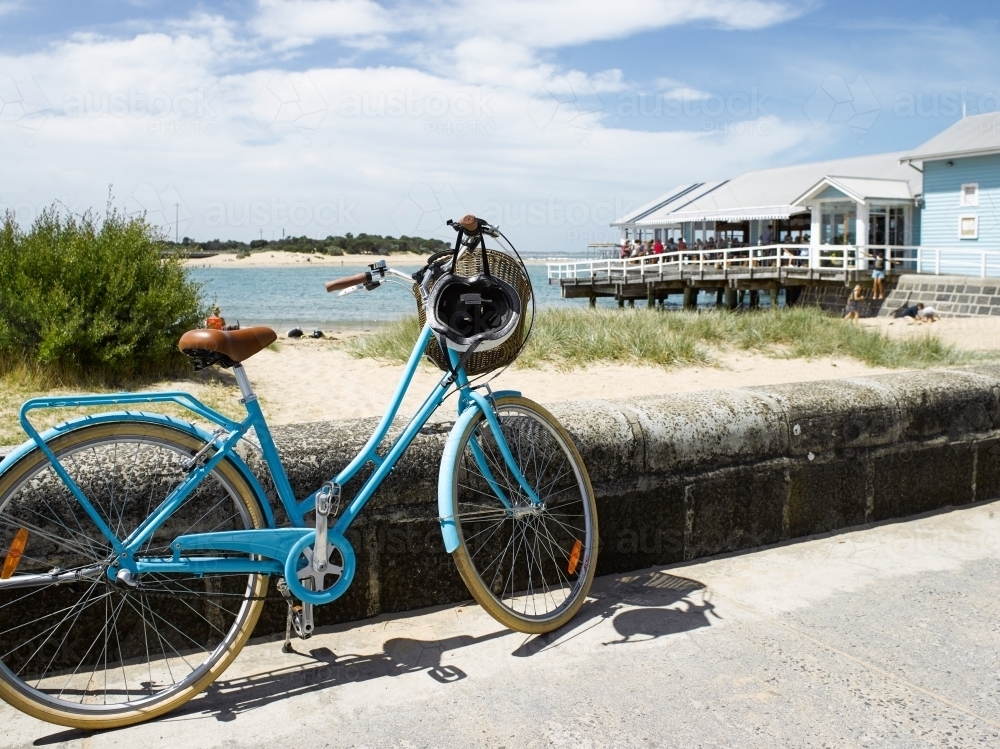 Push bike with restaurant and bay in background - Australian Stock Image