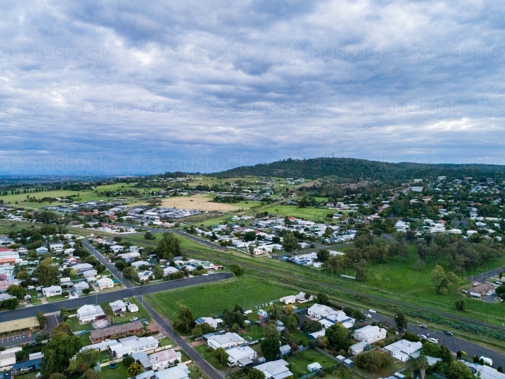 Railway line running through small country town of Gunnedah in the evening on overcast day - Australian Stock Image