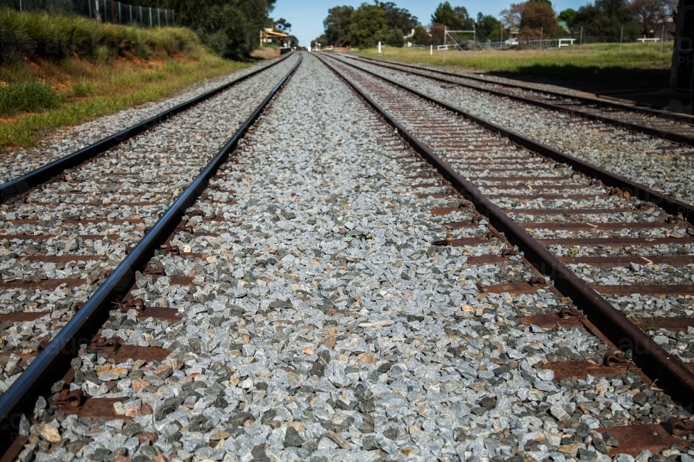 Railway, train tracks and gravel leading into distance - Australian Stock Image