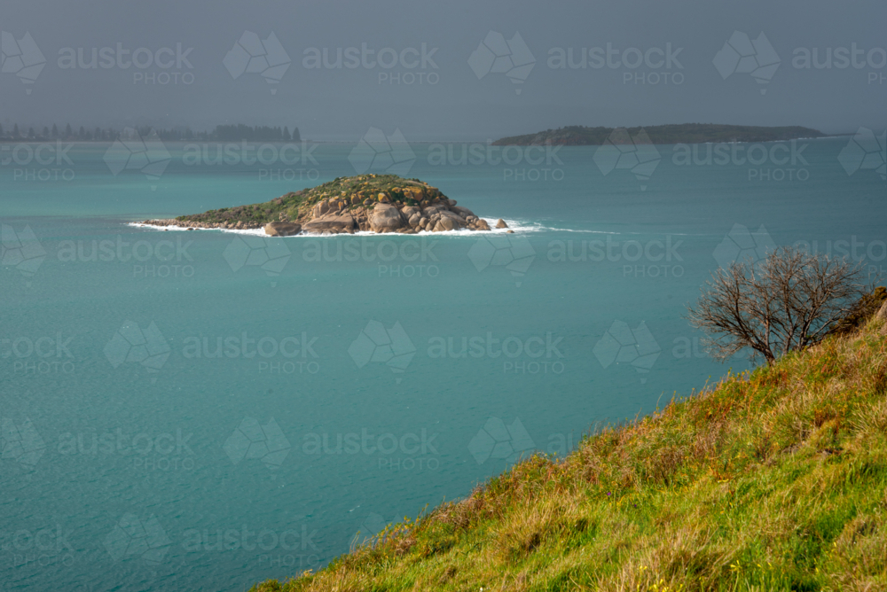Rain over island - Australian Stock Image