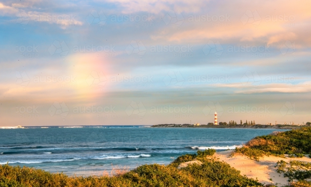 Rainbow cloud over the ocean - Australian Stock Image