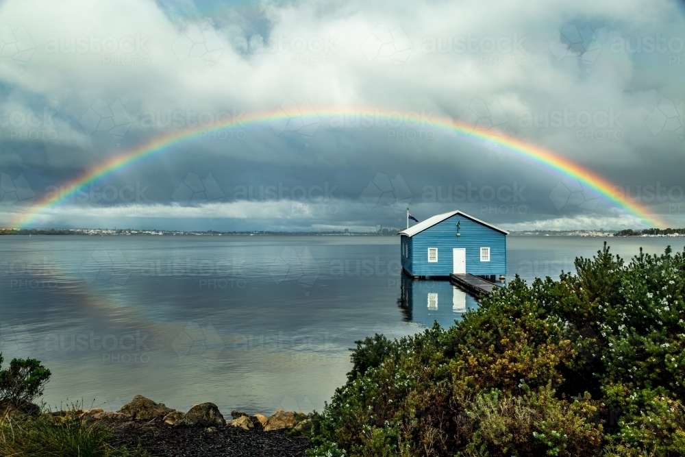 Rainbow over Crawley Edge blue boatshed, Perth, Western Australia, Australia - Australian Stock Image