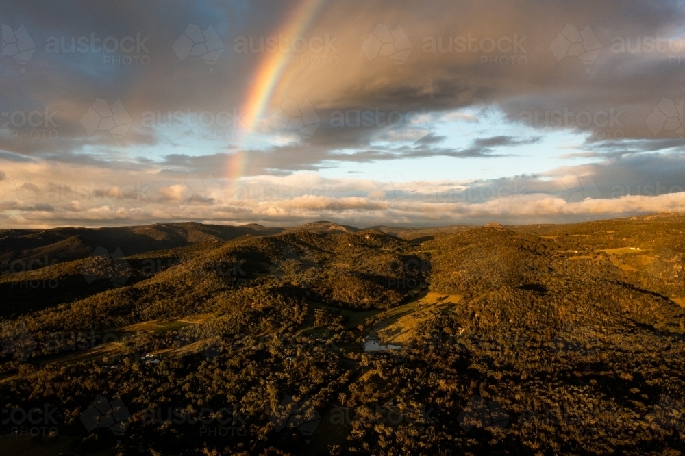 Rainbow over granite belt mountain landscape - Australian Stock Image