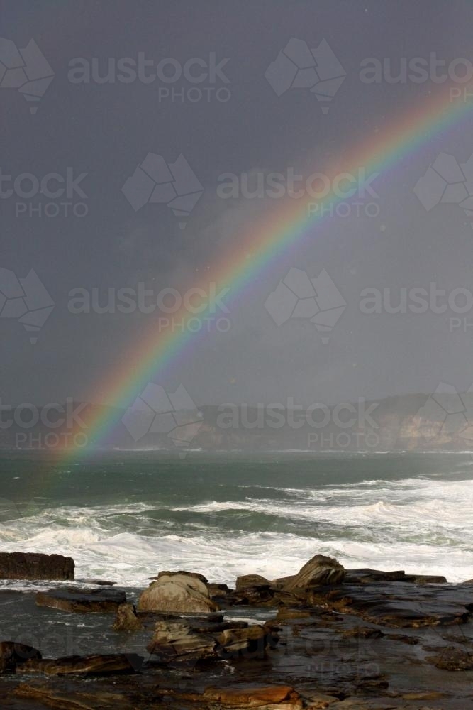 Rainbow over the ocean - Australian Stock Image