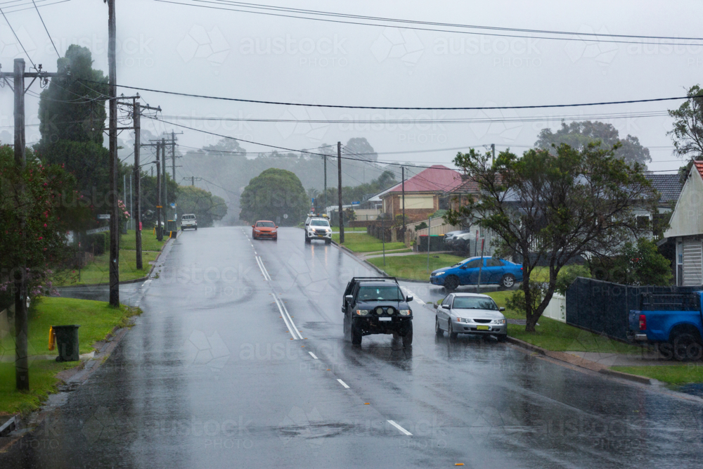 Rainy stormy day with vehicles driving on slippery wet road in Newcastle - Australian Stock Image