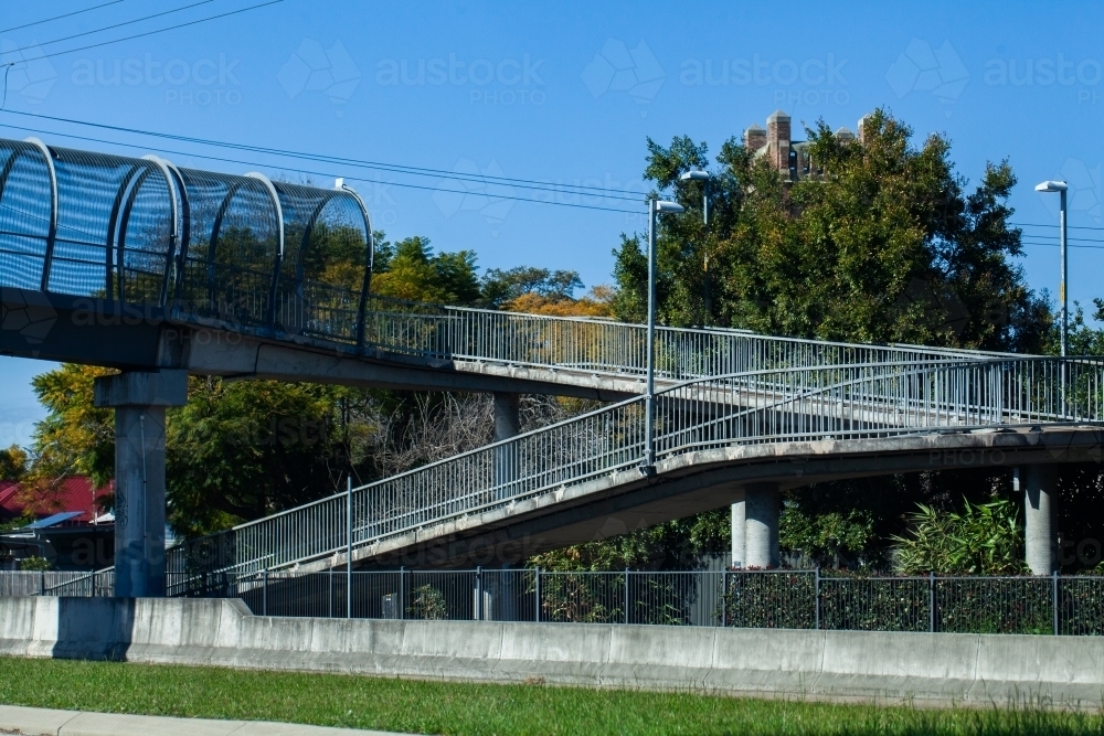 Ramp up pedestrian bridge to cross over busy road - Australian Stock Image