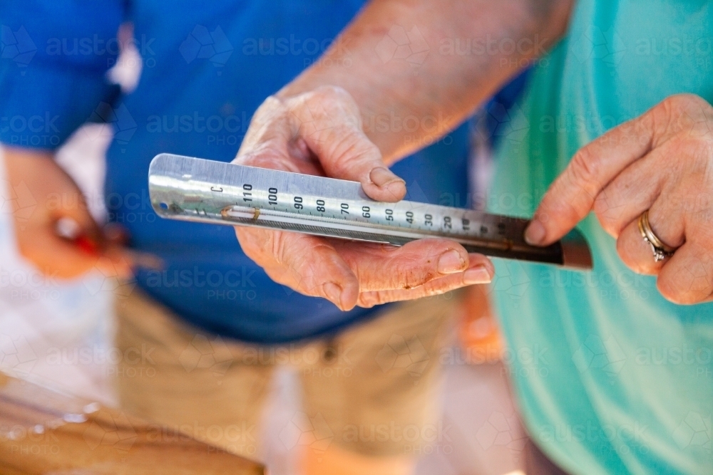 Reading temperature on thermometer - Australian Stock Image