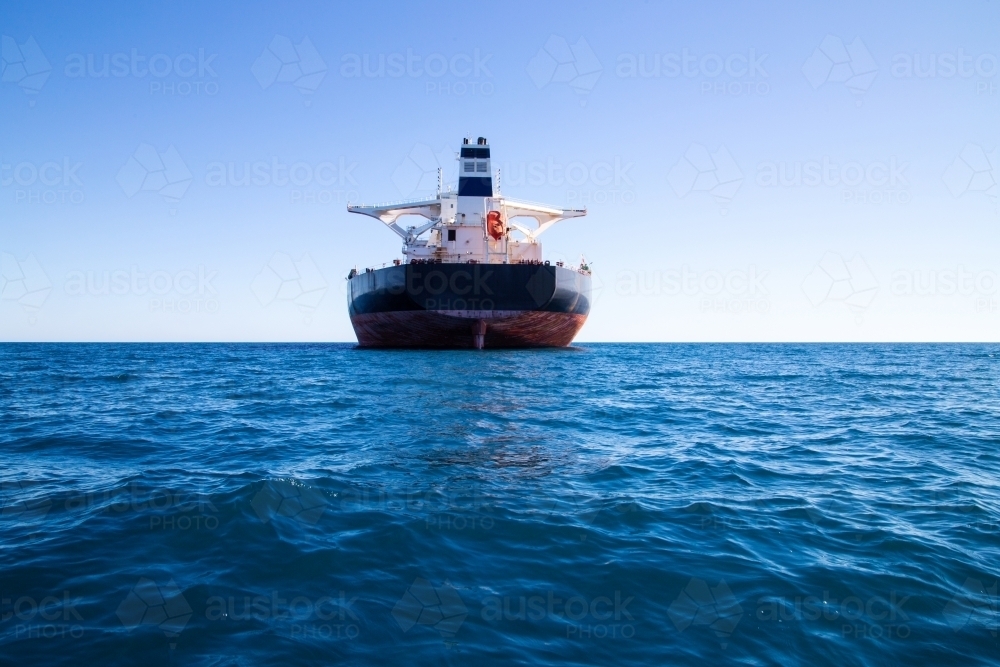 Rear view of freight ship offshore - Australian Stock Image