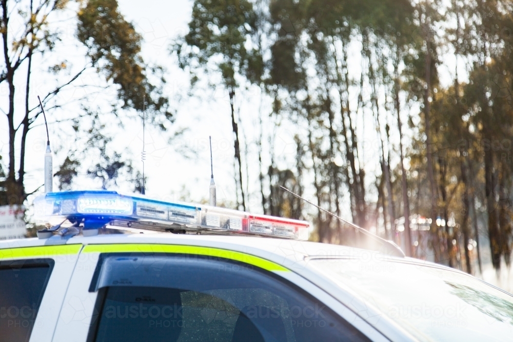 Red and blue flashing lights on top of emergency service vehicle - Australian Stock Image