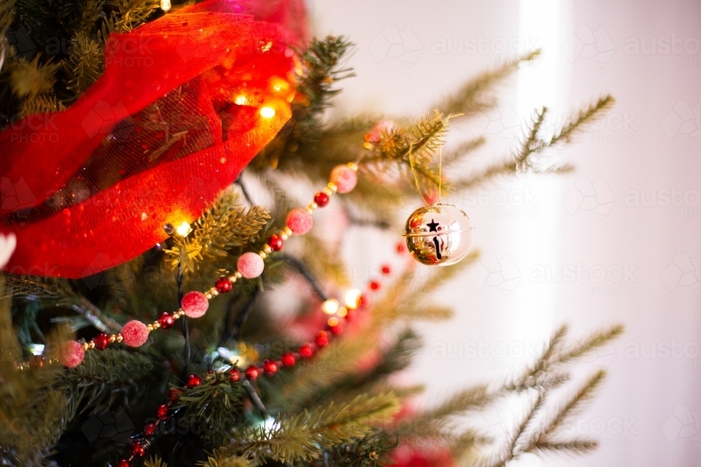 red and gold decorations hanging on a Christmas tree - Australian Stock Image