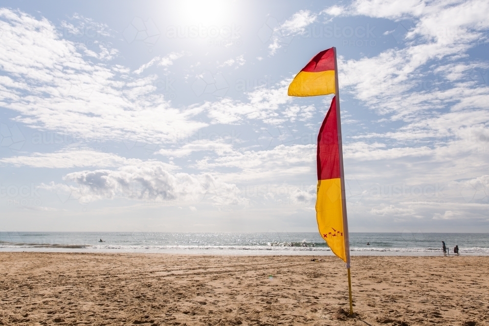 red and yellow flags at the beach - Australian Stock Image