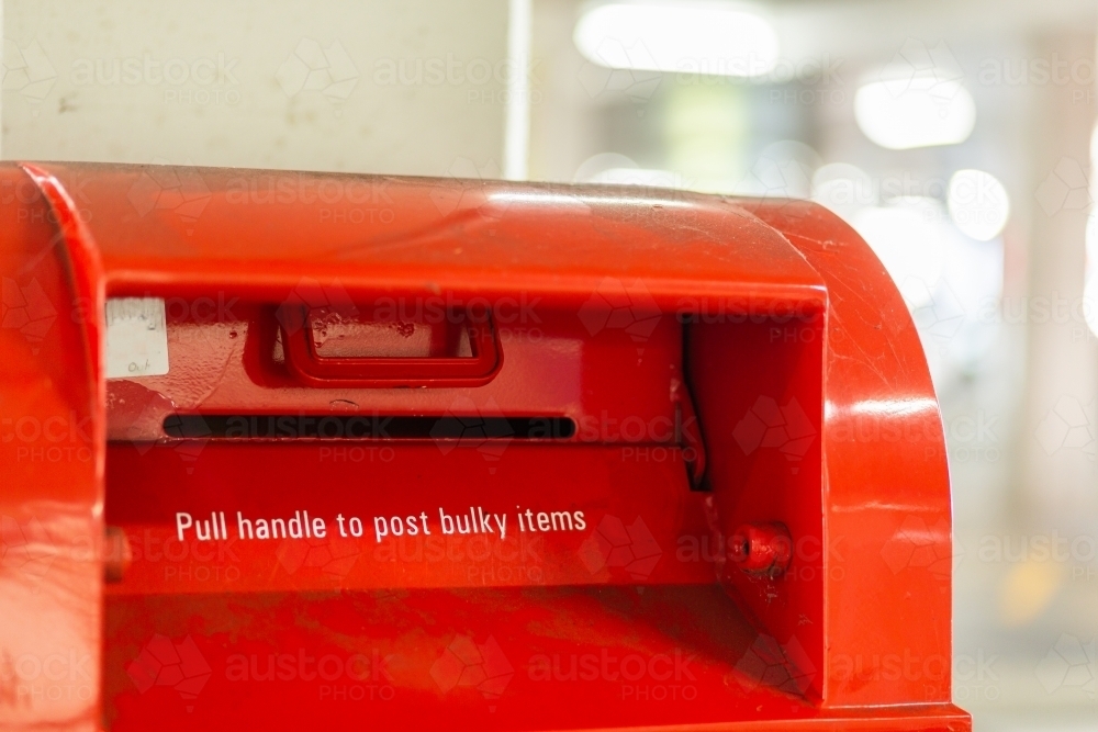 Red post box - pull handle to post bulky items - Australian Stock Image