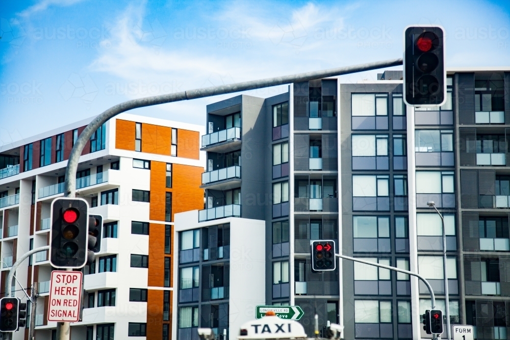 Red traffic light at intersection in city - Australian Stock Image